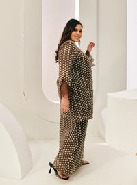 A woman dressed in Chocolate Tun Maryam Eyelet Kurung