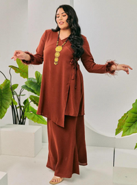 A woman dressed in Cinnamon Tun Malika Feather Wrap Kurung