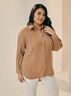 A woman dressed in Coffee Tun Izzah Pleated Top