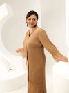 A woman dressed in Coffee Tun Jamilah Pleated Kurung