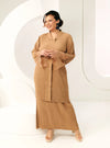 A woman dressed in Coffee Tun Jamilah Pleated Kurung