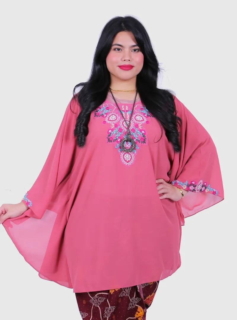 A woman dressed in Dusty Pink Cik Kembang Batwing