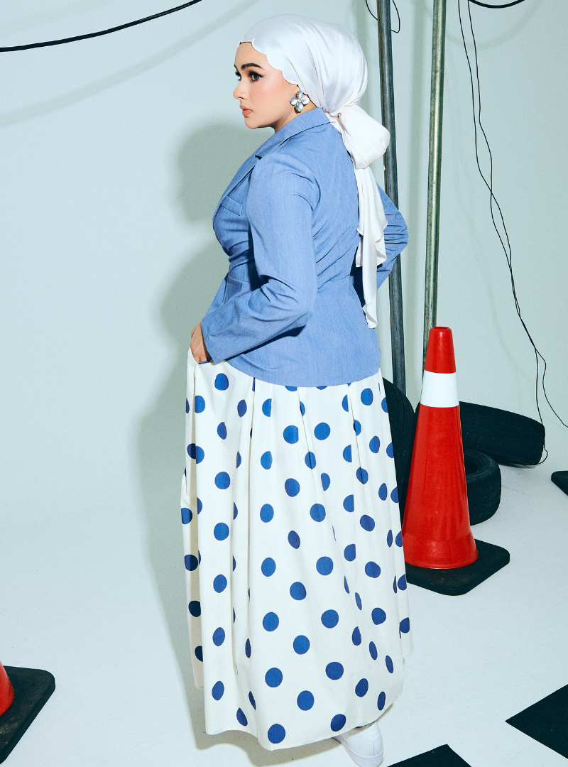 A woman wearing Denim Blue Amber Peplum Blazer