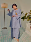 A woman dressed in Dusty Blue Tun Maryam Eyelet Kurung