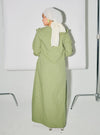 A woman dressed in Dusty Green Marsya Cotton Long Sleeve Dress