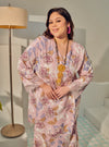 A woman dressed in Dusty Pink Tun Anum Printed Wrap Kurung