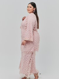 A woman dressed in Dusty Pink Tun Sharifah Lace Kurung