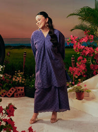 A woman dressed in Dusty Purple Tun Yasmin Embroidered Eyelet Oversized Kurung