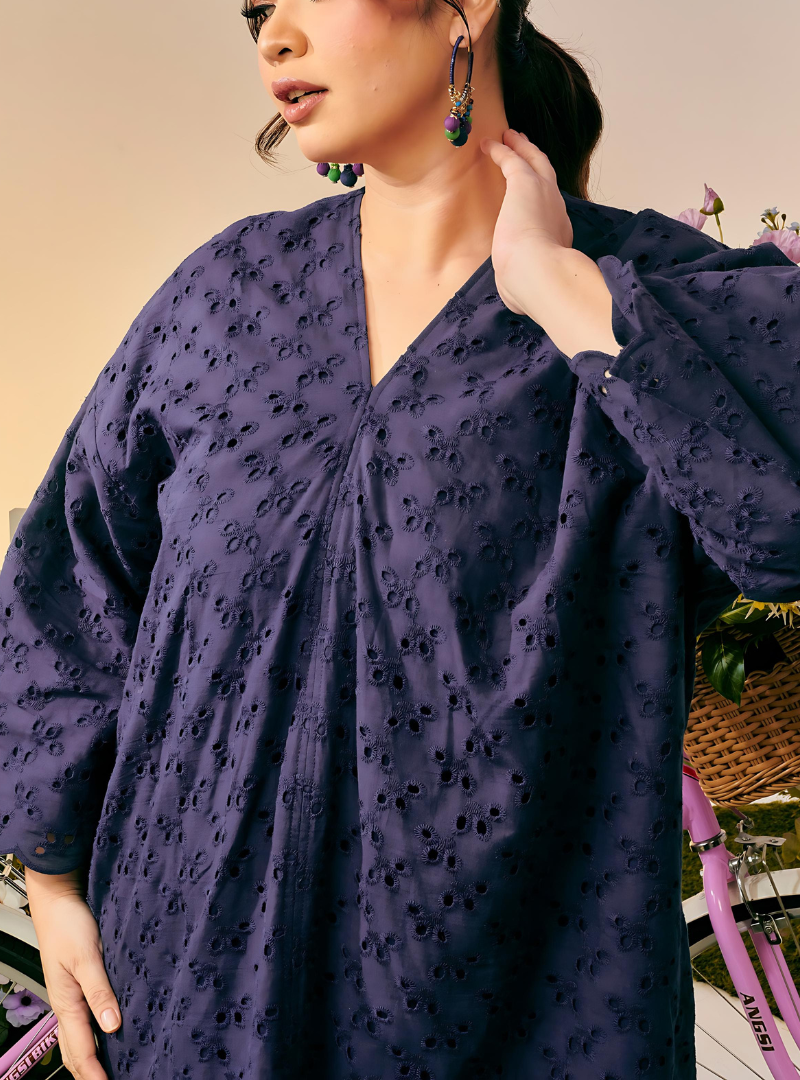 A woman dressed in Dusty Purple Tun Yasmin Embroidered Eyelet Oversized Kurung