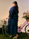 A woman dressed in Dusty Purple Tun Yasmin Embroidered Eyelet Oversized Kurung