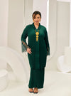 A woman dressed in Emerald Green Tun Jamilah Pleated Kurung