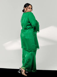 A woman dressed in Emerald Green Tun Sharimah Organza Kurung