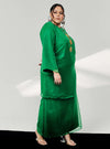 A woman dressed in Emerald Green Tun Sharimah Organza Kurung