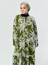 A woman dressed in Coconut Green The Bloom
