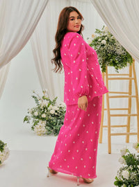  A woman dressed in Fuschia Tun Anisah Kebaya Kurung