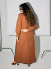 A woman dressed in Ginger Brown Marsya Cotton Long Sleeve Dress