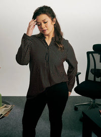 A woman dressed in Ginger Miyo Mandarin Collar Striped Polo Shirt