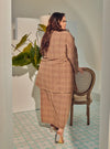 A woman dressed in Gingham Mocha Tun Zainab Vintage Checked Kurung