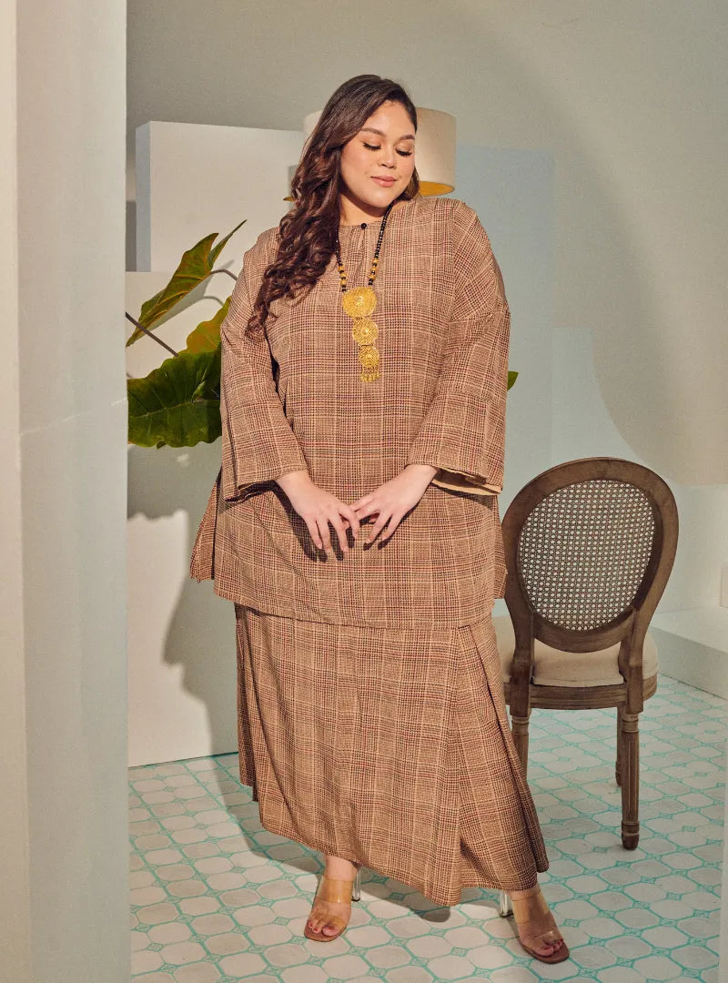 A woman dressed in Gingham Mocha Tun Zainab Vintage Checked Kurung