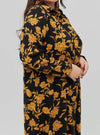 A woman dressed in Gold Chrysanthemum Flower Longline Printed Shirt Dress