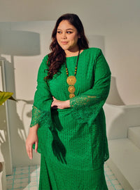 A woman dressed in Green Tun Inna Kurung