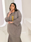 A woman dressed in Grey Tun Sharimah Organza Kurung