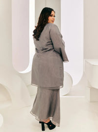 A woman dressed in Grey Tun Sharimah Organza Kurung