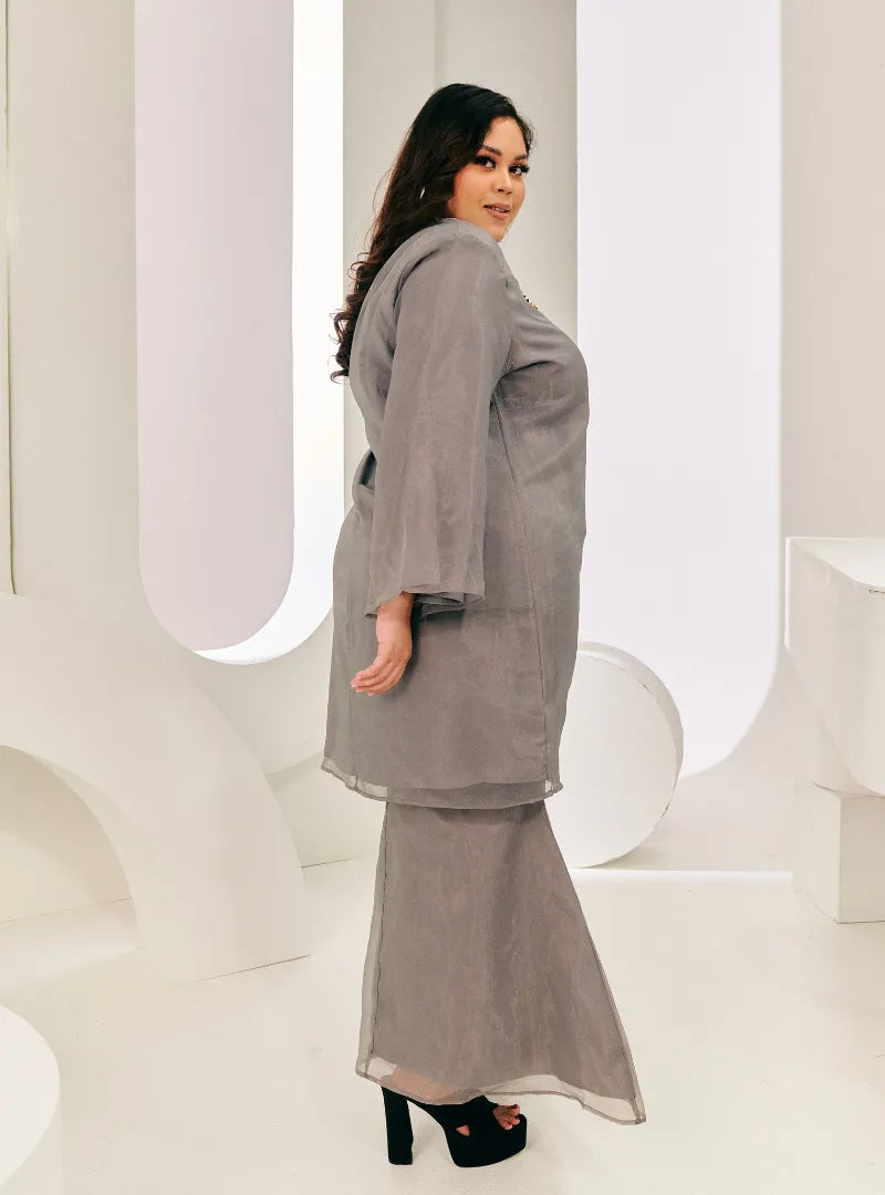 A woman dressed in Grey Tun Sharimah Organza Kurung