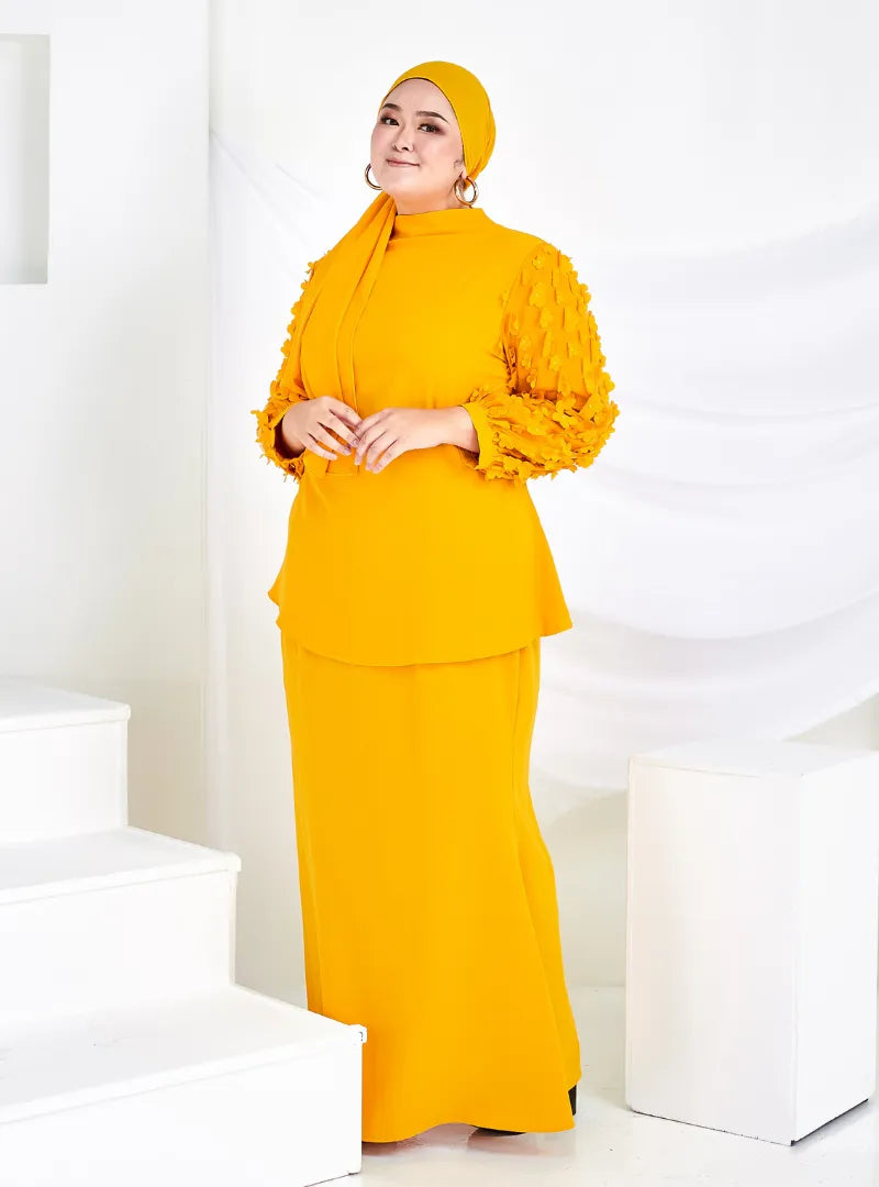 A woman dressed in Honey Mustard High Neck Butterfly Kurung