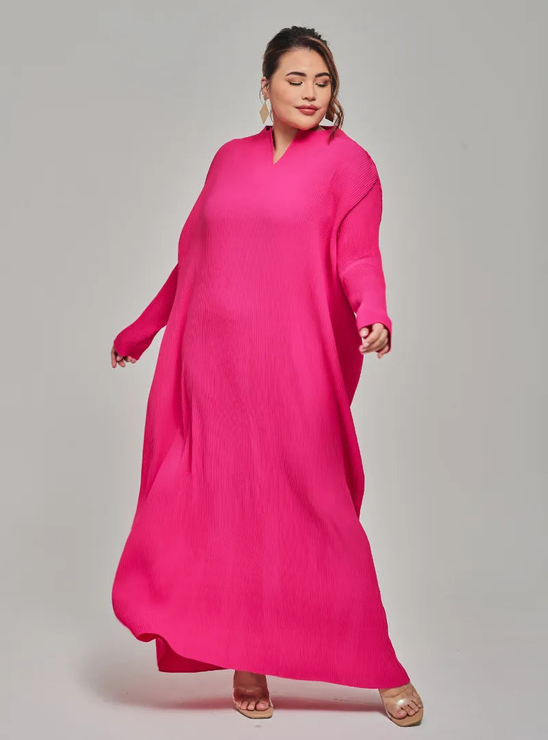 A woman dressed in Hot Pink Tun Aimellia Pleated Maxi Dress