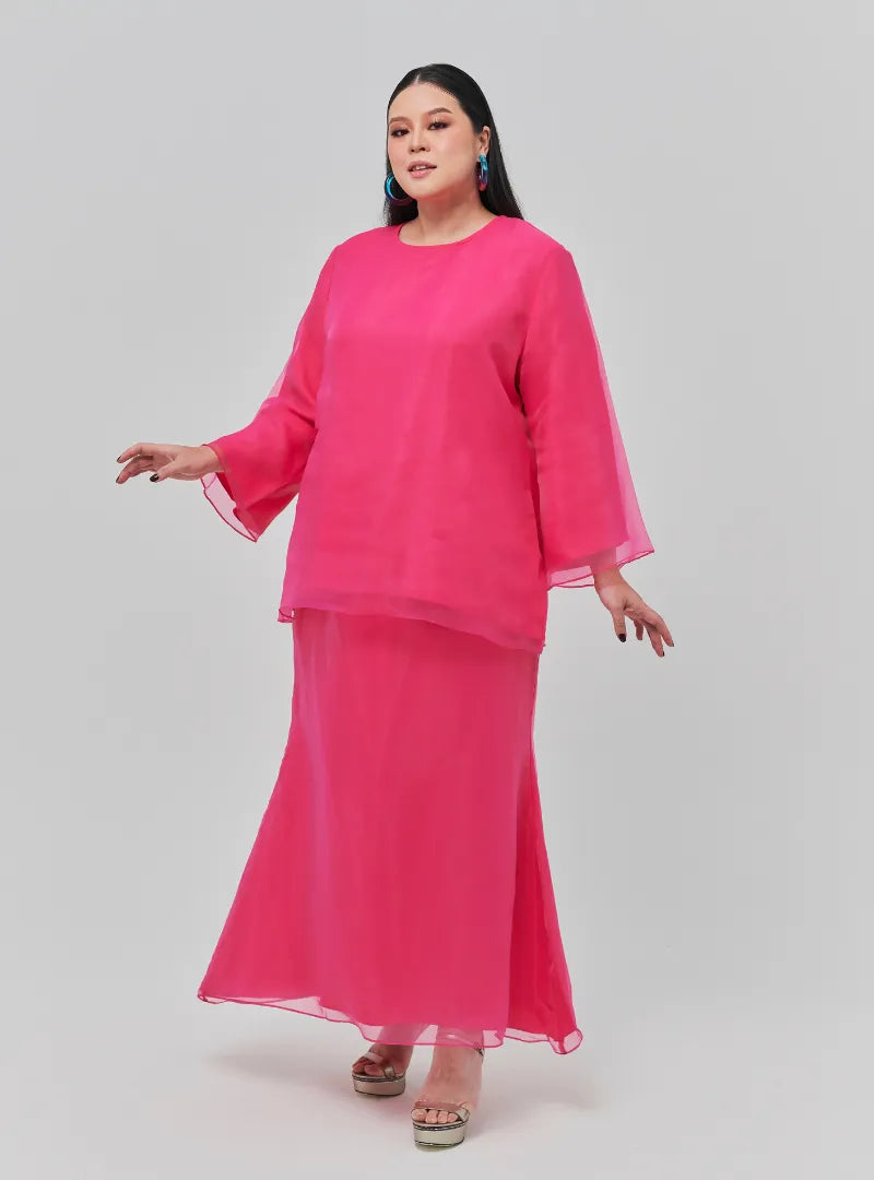 A woman dressed in Hot Pink Tun Aminah Organza Basic Kurung