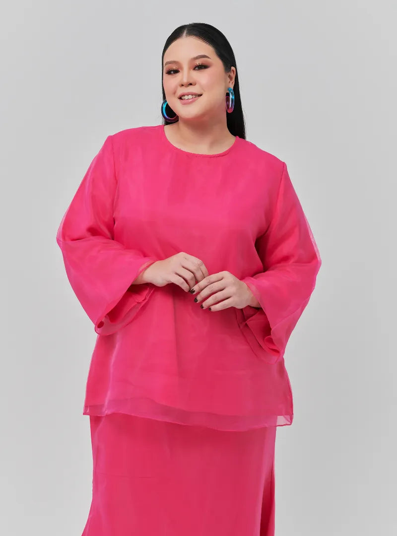 A woman dressed in Hot Pink Tun Aminah Organza Basic Kurung