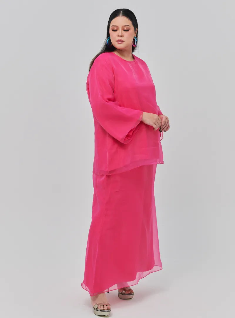 A woman dressed in Hot Pink Tun Aminah Organza Basic Kurung