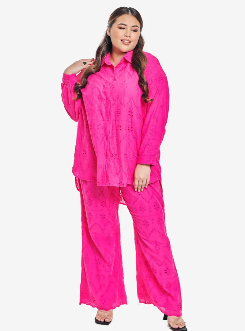 A woman dressed in Hot Pink Tun Hamzah Eyelet Trouser Set