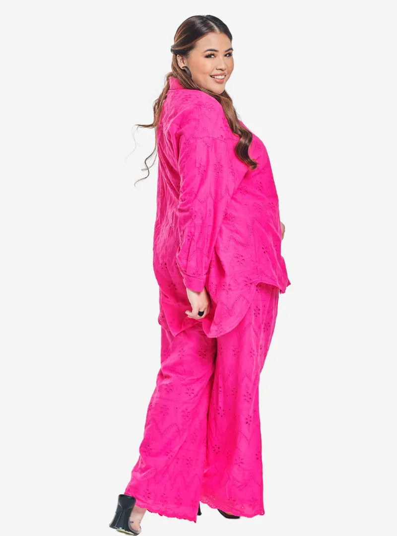 A woman dressed in Hot Pink Tun Hamzah Eyelet Trouser Set