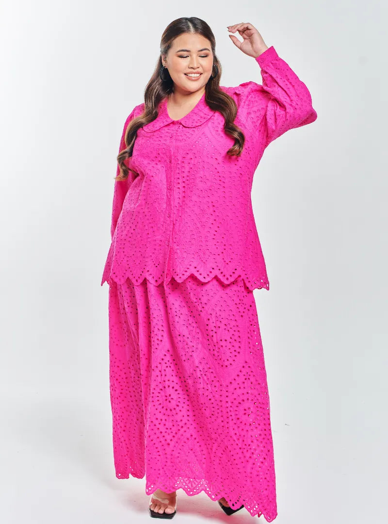 A woman dressed in Hot Pink Tun Hasmah Eyelet Skirt Set