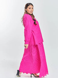 A woman dressed in Hot Pink Tun Hasmah Eyelet Skirt Set