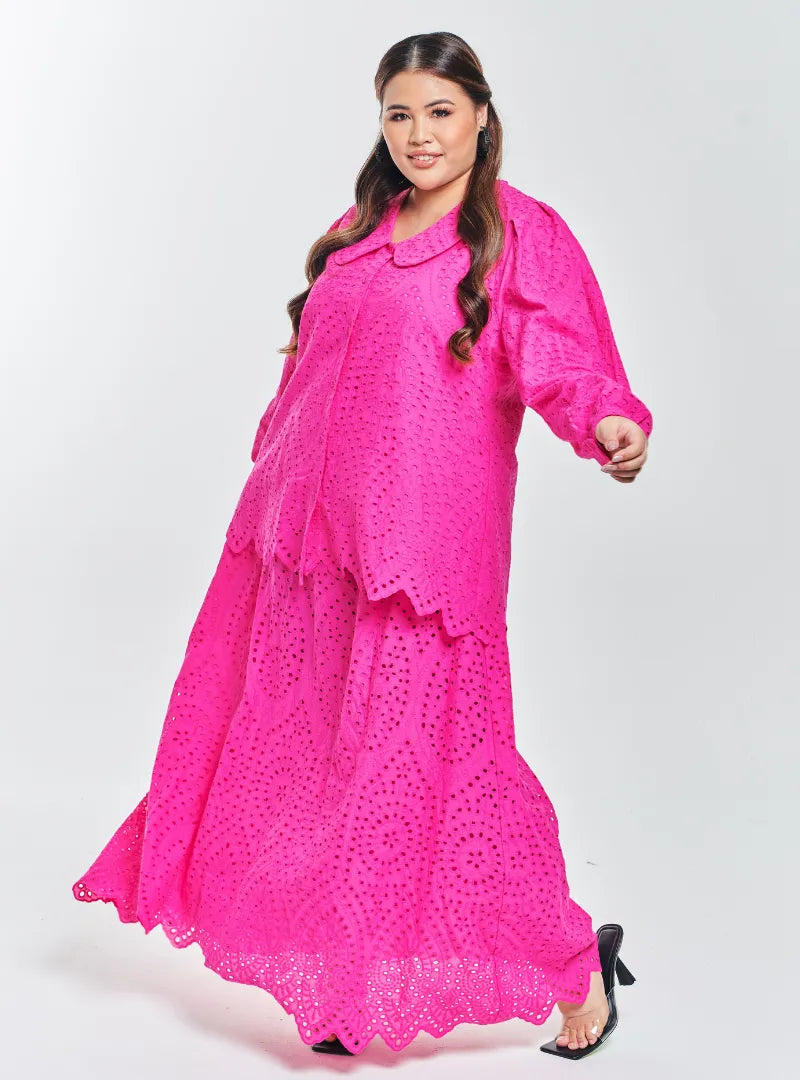 A woman dressed in Hot Pink Tun Hasmah Eyelet Skirt Set