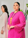 A woman dressed in Hot Pink Tun Inna Kurung