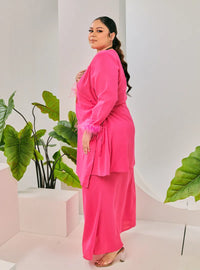 A woman dressed in Hot Pink Tun Malika Feather Wrap Kurung