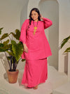 A woman dressed Hot Pink Tun Melur Dotted Kurung Pahang-