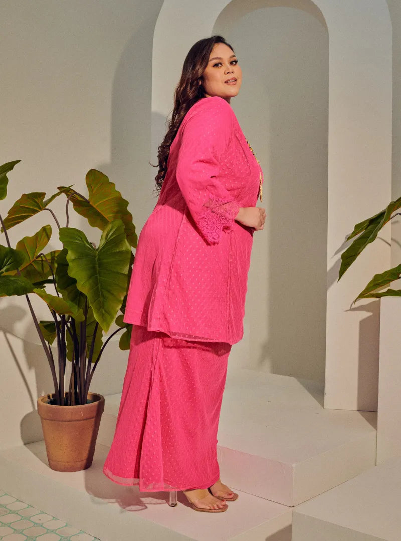 A woman dressed Hot Pink Tun Melur Dotted Kurung Pahang-