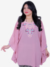 A woman dressed in Ice Pink Cik Kembang Batwing