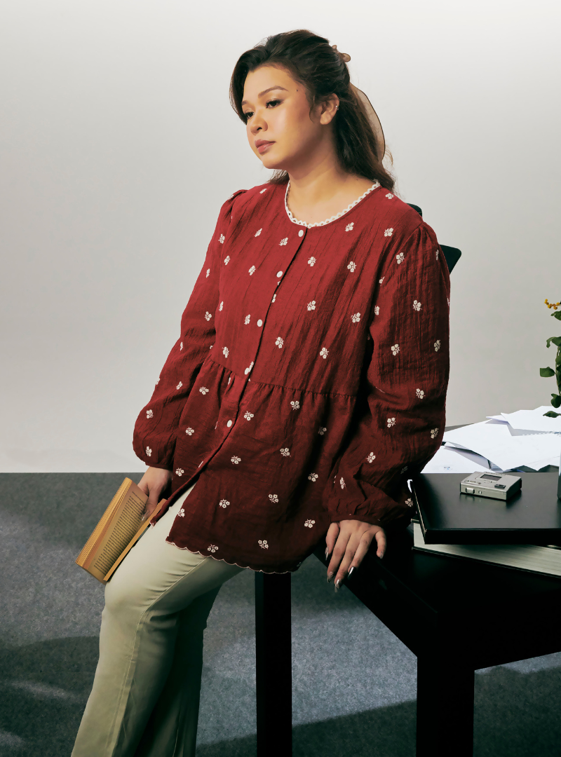 A woman dressed in Jam Red Arya Peplum Embroidered Top