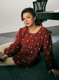 A woman dressed in Jam Red Arya Peplum Embroidered Top