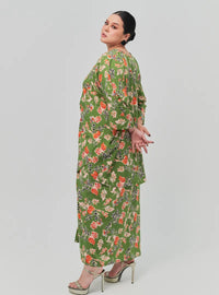 A woman dressed in Jowo Green The Vintage Opah Kurung