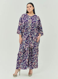 A woman dressed in Jowo Purple The Vintage Opah Kurung