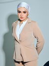 A woman wearing in Latte Amber Peplum Blazer