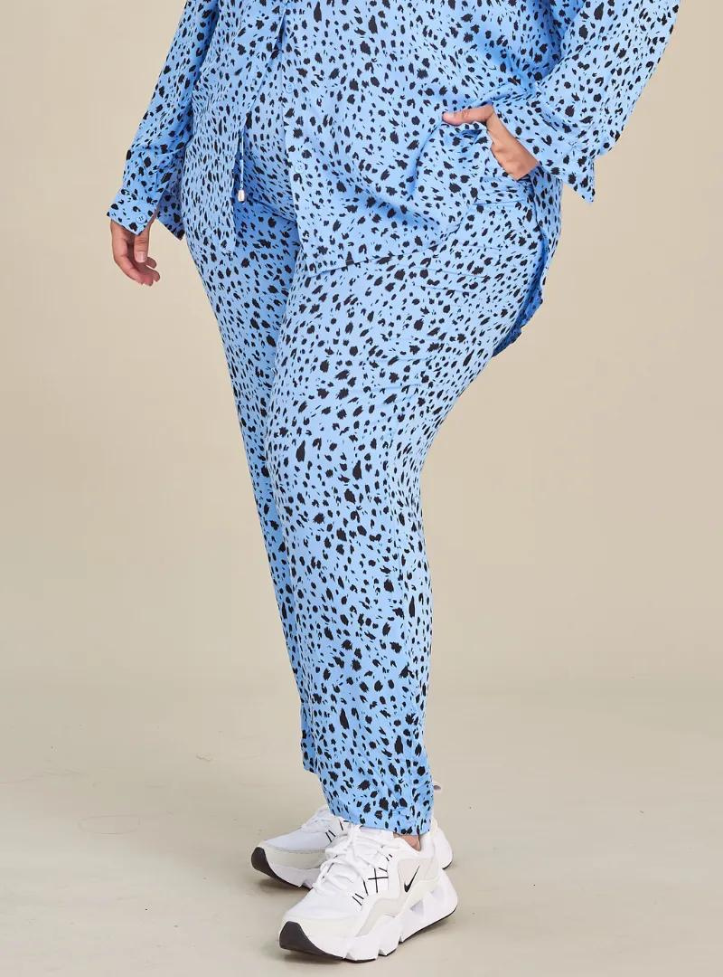 A woman wearing Leopard Blue Lounge Pants