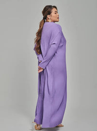 A woman dressed in Lilac Tun Aimellia Pleated Maxi Dress